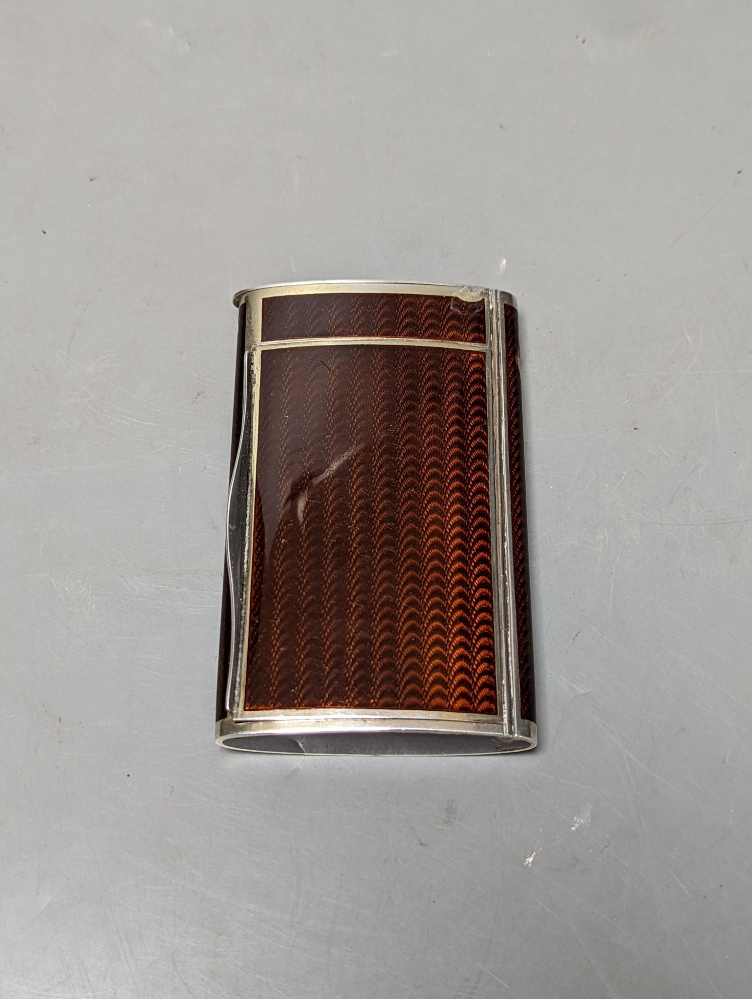 A 20th century Austro-Hungarian white metal and brown guilloche enamelled cigarette case, with match compartment?, 98mm (a.f.).